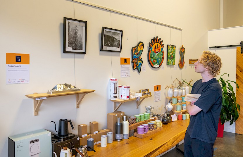 Man looking at art in a Squamish shop