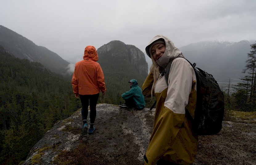 Father and son in the forest looking at an object outside of the frame