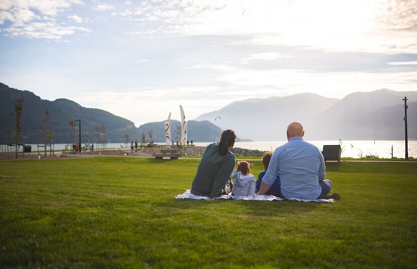 Family at the top of the Slhanay taking in the view of Squamish