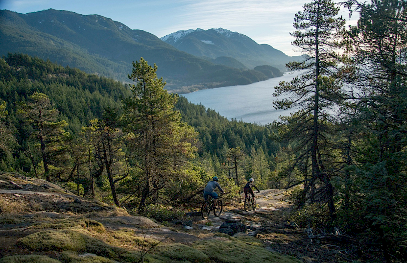 Couple biking with view over Squamish & Howe Sound