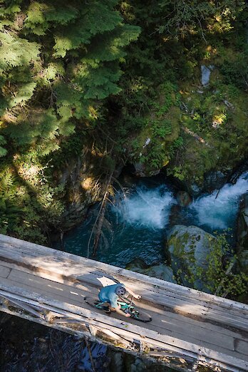 Mountain biker riding across bridge